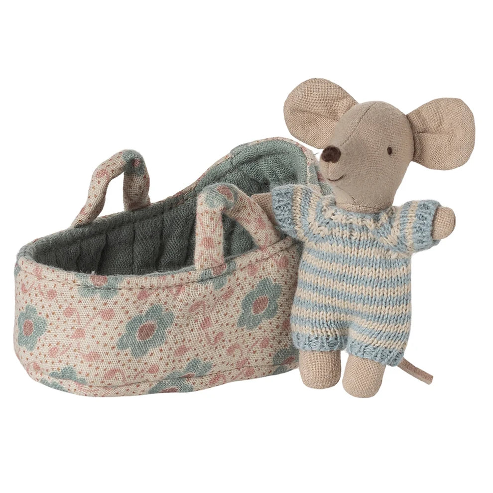 Stuffed mouse toy in a floral basket on a white background
