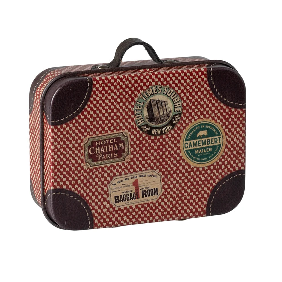 Red and brown checkered suitcase with vintage labels on a white background