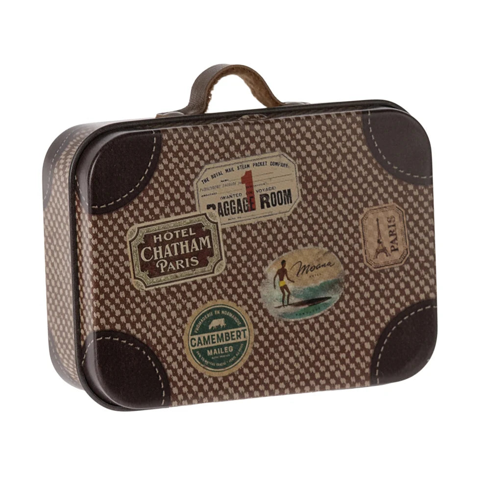 A vintage-style metal suitcase with a brown and beige houndstooth pattern, dark brown trim, and multiple retro travel stickers on the front, shown on a plain white background.